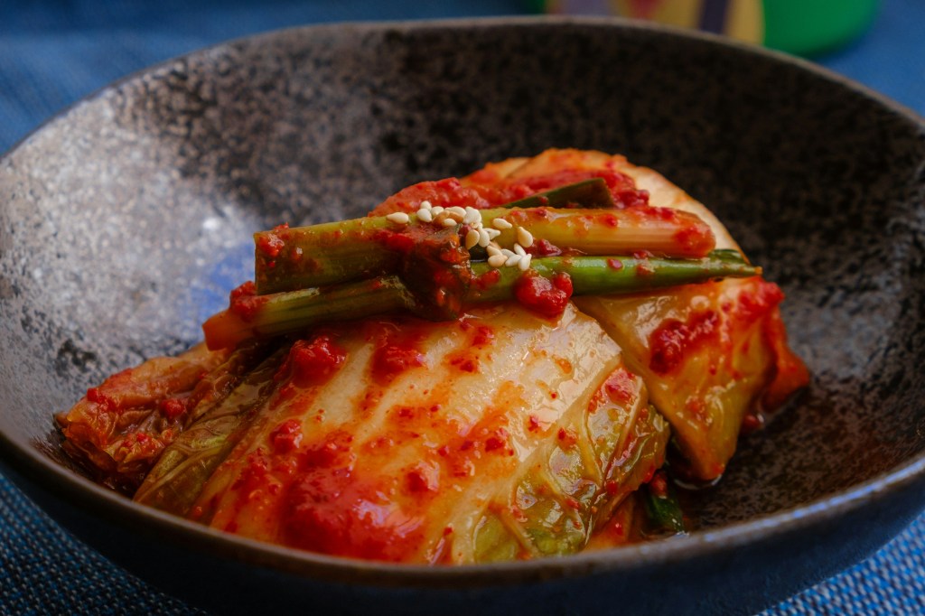 Close-up of red, fermented Korean baechu-kimchi in a bowl